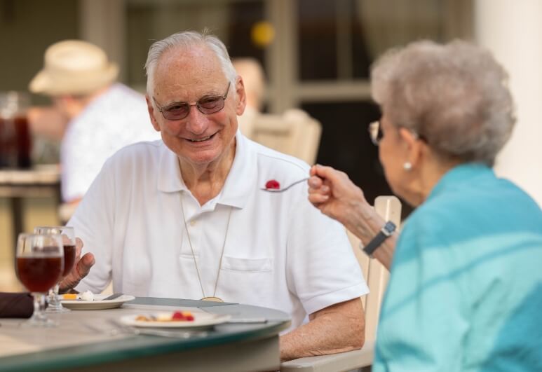 The Oaks at Bartlett | Two happy seniors eating dessert